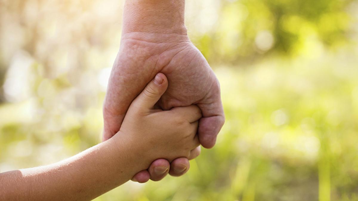 Child holding parent's hand