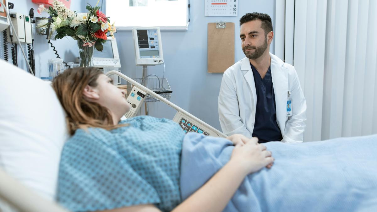 Doctor sitting at patient's bedside