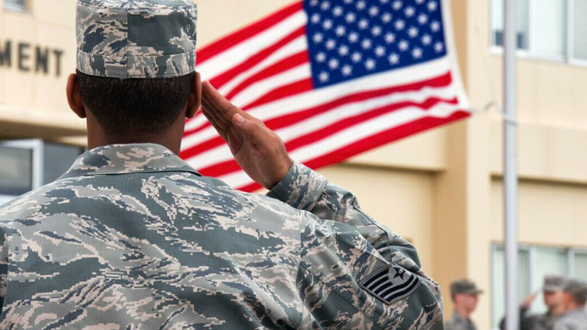 Veteran saluting the American flag